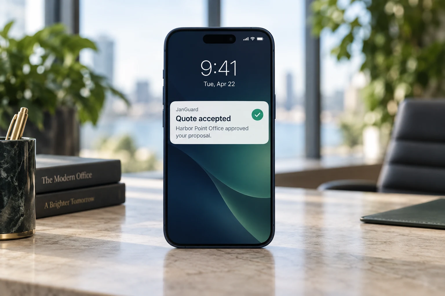 Phone showing a JanGuard Quote accepted notification for a sample office proposal